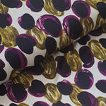   'Pebbles' polyester jersey in purple and green on an ivory background. Portia Jersey is a soft handle, slinky jersey, perfect for dresses skirts and tops.   Colours may vary due to differences in computer settings. Sold in half metre increments at Fabric Focus.