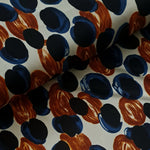   'Pebbles' polyester jersey in russet and blue on and ivory background. Portia Jersey is a soft handle, slinky jersey, perfect for dresses skirts and tops.   Colours may vary due to differences in computer settings. Sold in half metre increments at Fabric Focus.