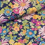 Beautiful colourful flowers on a dark navy background.  Perfect from shirts, tops, dresses and PJs. Available in half metre increments at Fabric Focus. Colours may vary due to differences in computer settings. 