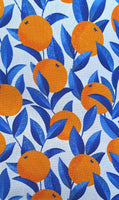 A wonderful medium dressmaking weight linen. Linen mixed with natural viscose. A digital print of zesty oranges with cobalt blue leaves on an off white background.  Available to buy in metre increments from Fabric Focus Edinburgh. 