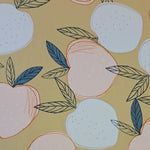 A stunning print of white and peach coloured apples with black/green leaves on a sand ochre background. Perfect for wrap dresses, wide legged trousers and blouses. Great for all summer designs including trousers and dresses. Sold in half metre increments.