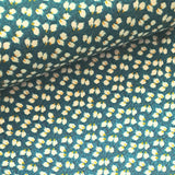 A beautiful ditzy floral of white and yellow on a rich teal background viscose fabric. Perfect for wrap dresses, wide legged trousers and blouses. Great for all summer designs including trousers and dresses. Sold in half metre increments.