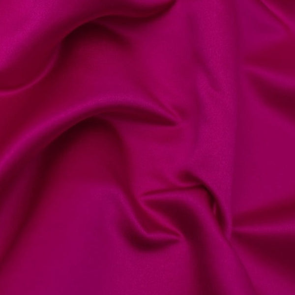 Duchess Satin fabric is a highly lustrous, smooth, very finely woven heavy non stretch satin. It has a very subtle sheen that is classic and elegant and very different in appearance to most satins which generally have a high gloss finish. This is the colourful Fuchsia. Sold in half meter lengths at Fabric Focus.