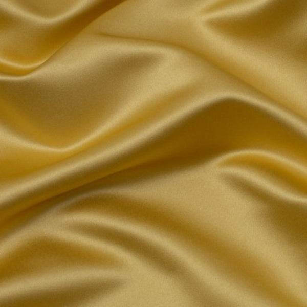 Duchess Satin fabric is a highly lustrous, smooth, very finely woven heavy non stretch satin. It has a very subtle sheen that is classic and elegant and very different in appearance to most satins which generally have a high gloss finish. This is the soft Golden. Sold in half meter lengths at Fabric Focus.