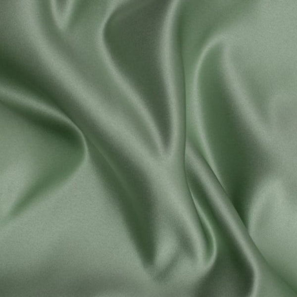 Duchess Satin fabric is a highly lustrous, smooth, very finely woven heavy non stretch satin. It has a very subtle sheen that is classic and elegant and very different in appearance to most satins which generally have a high gloss finish. This is the soft Sage Green. Sold in half meter lengths at Fabric Focus.