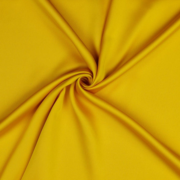 A beautiful soft polyester satin that has a subtle sateen sheen rather than a high gloss finish usually associated with satins. Because of this it has a high-end expensive look. Perfect for evening wear and day wear alike! This being the gorgeous yellow colourway.  Sold in half meter lengths at Fabric Focus.