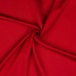 A beautiful soft polyester satin that has a subtle sateen sheen rather than a high gloss finish usually associated with satins. Because of this it has a high-end expensive look. Perfect for evening wear and day wear alike! This being the classic red colourway.  Sold in half meter lengths at Fabric Focus.