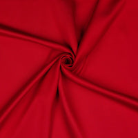 A beautiful soft polyester satin that has a subtle sateen sheen rather than a high gloss finish usually associated with satins. Because of this it has a high-end expensive look. Perfect for evening wear and day wear alike! This being the classic red colourway.  Sold in half meter lengths at Fabric Focus.
