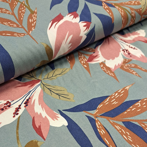 tropical print of leaves and flowers in rose pink, navy and brown on a sage green background in a super soft 100% viscose.