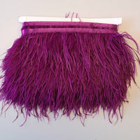 Super Luxurious Ostrich Feather trim, coloured and on co-ordinating coloured ribbon. Great for dressmaking, crafting, home decor and costume. A fashionable rich magenta pink  colour-way on a co-ordinating ribbon. Sold in metre increments
