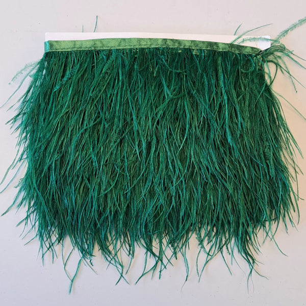 Super Luxurious Ostrich Feather trim, coloured and on co-ordinating coloured ribbon. Great for dressmaking, crafting, home decor and costume. A fashionable rich forest green colour-way on a co-ordinating ribbon. Sold in metre increments