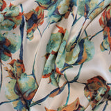 Cream with orange, blue and green leaf motifs make up this beautiful soft satin with amazing drape! Available to buy in half metre increments at Fabric Focus