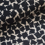 This soft and drapey polyester crepe fabric is a medium weight and is completely opaque, so perfect for sewing tops, skirts, dresses, trousers and jumpsuits. Ivory background with dark navy geometric squares. Available to buy in half metre increments at Fabric Focus.