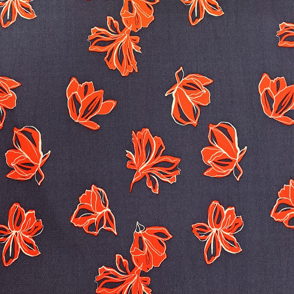 A stunning print of red flowers on a denim navy background. Perfect for wrap dresses, wide legged trousers and blouses. Manufacturer recommends 30 degree wash but please allow for shrinkage and test a piece before hand.  Sold in half metre increments at Fabric Focus Edinburgh.