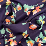 A stunning print of coral, yellow and green flowers on a navy background. Perfect for wrap dresses, wide legged trousers and blouses. Manufacturer recommends 30 degree wash but please allow for shrinkage and test a piece before hand.  Sold in half metre increments at Fabric Focus Edinburgh.
