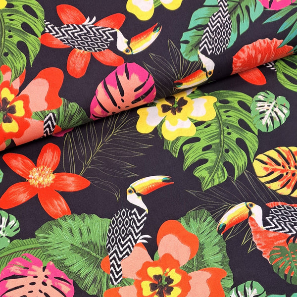 Modern, fun tropical print of flowers and Toucans on a black background, great for summer dresses and shirts! Sold in half metre increments at Fabric Focus.