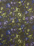Textured fabric with green and purple pattern