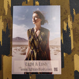 Product packaging with a scenic image and 'Light & Lush' branding on a camouflage-patterned surface.