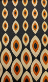 Patterned fabric with eye-like design on a dark background