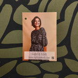 Gorgeous viscose twill of modern green pebble shapes on a black background available at Fabric Focus Edinburgh