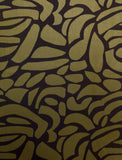 Gorgeous viscose twill of modern green pebble shapes on a black background available at Fabric Focus Edinburgh