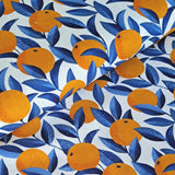 A wonderful medium dressmaking weight linen. Linen mixed with natural viscose. A digital print of zesty oranges with cobalt blue leaves on an off white background.  Available to buy in metre increments from Fabric Focus Edinburgh. 