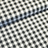 Incredibly versatile, our yarn-dyed* 100% cotton gingham fabric is ideal as a dress fabric and eternally popular for school uniforms, tablecloths, bunting, curtains, aprons, cushions, craft projects, Christmas decorations and much, much more. This being the black colourway. Available to buy at Fabric Focus.