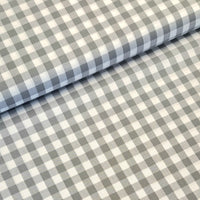 Incredibly versatile, our yarn-dyed* 100% cotton gingham fabric is ideal as a dress fabric and eternally popular for school uniforms, tablecloths, bunting, curtains, aprons, cushions, craft projects, Christmas decorations and much, much more. This being the soft grey colourway. Available to buy at Fabric Focus.