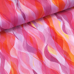 Gorgeous viscose print of shades of pinks, lilacs and orange in ribbon waves. Wonderful for dressmaking, tops, skirts and wide leg trousers. Available to buy online at fabric Focus in half metre increments.