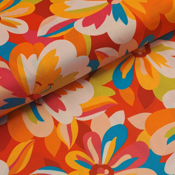 Gorgeous viscose floral print in reds, oranges and turquoise. Wonderful for dressmaking, tops, skirts and wide leg trousers. Available to buy online at fabric Focus in half metre increments.