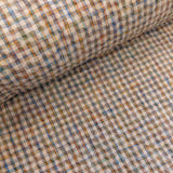 Close-up of checkered fabric with brown, blue, and beige colors.