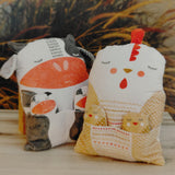 Two decorative pillows with animal designs on a wooden surface.