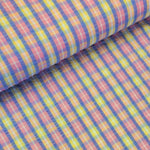 Beautiful cotton polyester mix seersucker in a summer check plaid of pink, lilac and yellow. Available to buy at Fabric Focus Edinburgh.