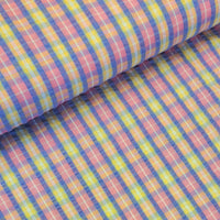 Beautiful cotton polyester mix seersucker in a summer check plaid of pink, lilac and yellow. Available to buy at Fabric Focus Edinburgh.