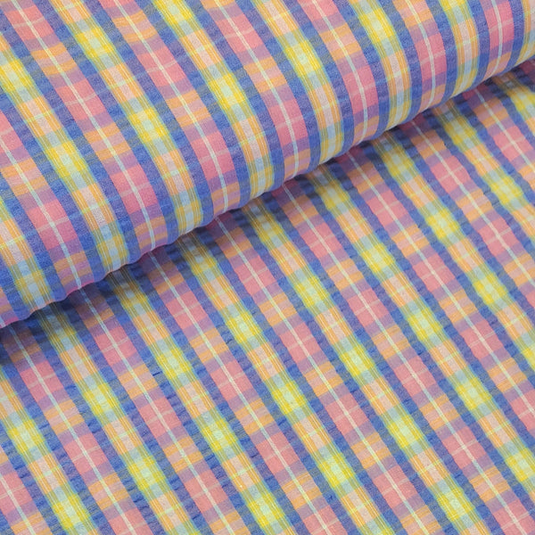 Beautiful cotton polyester mix seersucker in a summer check plaid of pink, lilac and yellow. Available to buy at Fabric Focus Edinburgh.