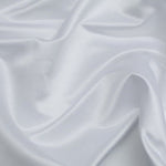 Duchess Satin fabric is a highly lustrous, smooth, very finely woven heavy non stretch satin.  This is the classic White colourway. Sold at Fabric Focus.