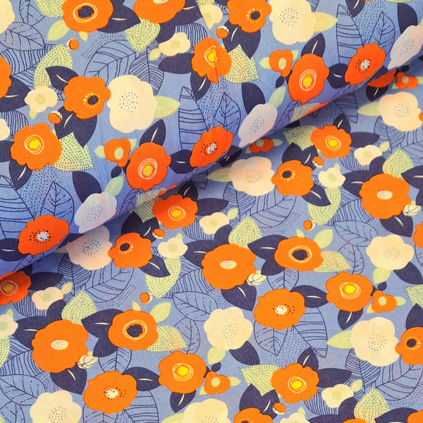 Cotton Print perfect for making shirts, dresses, lightweight trousers and skirts. Floral print of orange on a denim blue background. Sold at Fabric Focus.