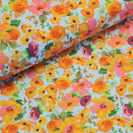 Cotton Print perfect for making shirts, dresses, lightweight trousers and skirts. Floral print of orange/yellow on off-white background Sold @ Fabric Focus.