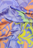 Polyester with lilac background and gold and orange oversized 'plumes'. Available to buy in half metre increments at Fabric Focus.