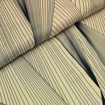 A striking print of multiple black lines on a cream background.  Sold in half metre increments at Fabric Focus Edinburgh.
