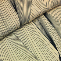A striking print of multiple black lines on a cream background.  Sold in half metre increments at Fabric Focus Edinburgh.