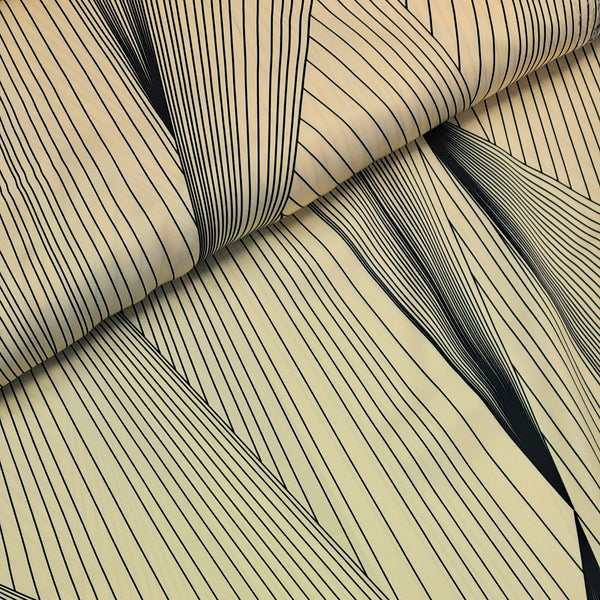 A striking print of multiple black lines on a cream background.  Sold in half metre increments at Fabric Focus Edinburgh.