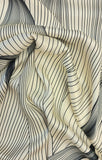 A striking print of multiple black lines on a cream background.  Sold in half metre increments at Fabric Focus Edinburgh.