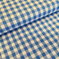 Incredibly versatile, our yarn-dyed* 100% cotton gingham fabric is ideal as a dress fabric and eternally popular for school uniforms, tablecloths, bunting, curtains, aprons, cushions, craft projects, Christmas decorations and much, much more. This being the royal blue colourway. Available to buy at Fabric Focus.