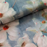 A beautiful grey blue background with white paint brush floral print, reminiscent of a Monet masterpiece on a soft viscose fabric. perfect for wrap dresses, wide legged trousers and blouses. Sold in half metre increments at Fabric Focus Edinburgh.