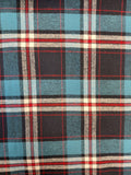 A close-up of a plaid fabric pattern featuring light blue, black, white, and red stripes.