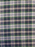 A close-up of a green, navy, and cream plaid fabric pattern.