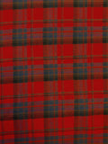 A close-up of a red tartan plaid fabric with blue and black stripes.