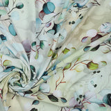 A beautiful print of eucalyptus leaves in shades of green, blue and lilac on a shaded green ivory background. Perfect for wrap dresses, wide legged trousers and blouses. Manufacturer recommends 30 degree wash but please allow for shrinkage and test a piece before hand.  Sold in half metre increments at Fabric Focus Edinburgh.