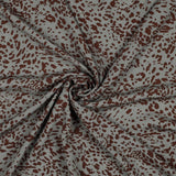 A stunning new animal print of burgundy animal print on a green/grey background. Perfect for wrap dresses, wide legged trousers and blouses.  Sold in half metre increments at Fabric Focus Edinburgh.